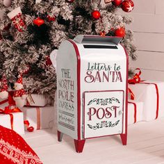 a mailbox next to a christmas tree with presents