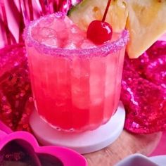 a pink drink with cherries and a slice of pineapple