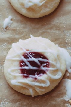 a pastry with icing and jelly on it sitting on top of a countertop