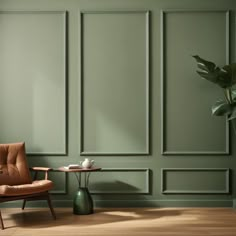 a chair and table in front of a green wall with paneled panels on it