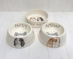 three bowls with dogs painted on them