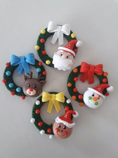 christmas ornaments are arranged in the shape of wreaths and santa's head on each ornament