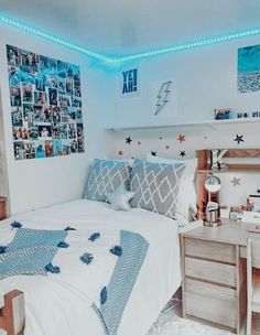 a bed room with a neatly made bed and pictures on the wall