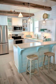 a kitchen with an island and two stools