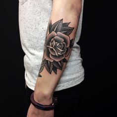 a woman with a rose tattoo on her arm