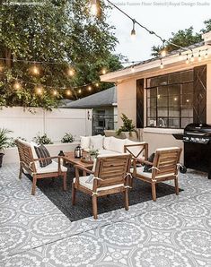 an outdoor living area with patio furniture and string lights