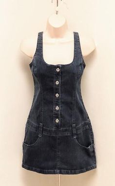 ALL SALES FINAL. PLEASE ASK QUESTIONS PRIOR TO PURCHASE. WE DO NOT ACCEPT OFFERS OR NEGOITATE ON PRICING. THANK YOU! Vintage 1990s 90s Sleeveless Blue Jean Denim Mini Jumper Dress Grunge Small S By Andrea Jeans.  Medium Blue Stone Washed denim, fixed straps, darts in bust.  Two functioning hip pockets and four wide belt loops. Metal Rivet Buttons placket to the hem. The back of the dress has two back faux pockets. Pencil (straight) cut skirt. The condition of the garment is very good without stains, tears, or issues.  The fabric is strong, and the colors are good!.  Dress has been laundered/pressed. The garment is clean and ready to be worn.  ZOOM IN ON PHOTOS. MEASUREMENTS-- Your own body measurements must be smaller or the item will not fit. We do not accept returns for items that do not Denim Vintage Dress, 90s Denim Dress, Dress Grunge, Vintage Denim Dress, 90s Clothes, Good Dress, Jean Dress, 90s Denim, 90s Grunge