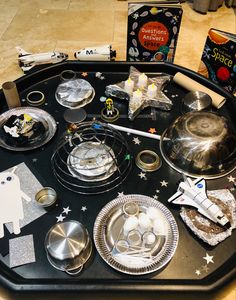 a black table topped with lots of silver dishes