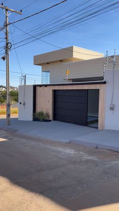 a white house with a black garage door