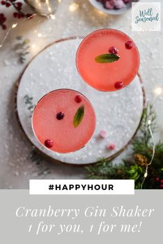 two glasses filled with cranberry gin shakers on top of a white plate