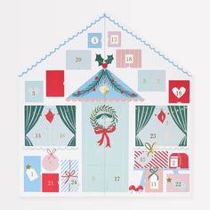 a house shaped calendar with christmas decorations on it