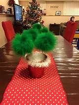 a table topped with a vase filled with green pom - poms