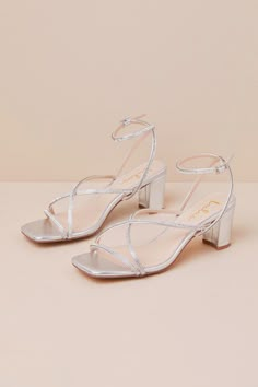 From cute date nights to wedding invites, step out with confidence in the Lulus Makenna Silver Rhinestone Strappy Ankle Strap Low Heel Sandals! These wear-with-anything sandals have a smooth faux leather construction that shapes a trendy square footbed with a slender toe strap and crisscrossing vamp straps. An adjustable ankle strap sprouts from the sides and secures with a shiny silver buckle, all atop a cute block heel. Glittery, dainty rhinestone details throughout lend an extra fabulous fini Flat Hoco Shoes, Grad Shoes Flats, Silver Heels Short, Short Silver Heels, Prom Shoes Flat, Prom Shoes Low Heeled, Drippy Shoes, Hoco Heels, Hoco Shoes