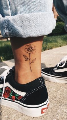 a woman's foot with a rose tattoo on the side of her lower leg