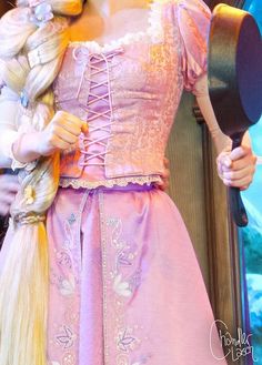 a barbie doll with long blonde hair wearing a pink dress