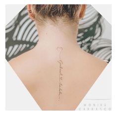 the back of a woman's neck with a heart tattoo on her left side