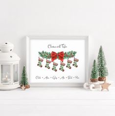 a white mantle topped with christmas decorations and a framed poster next to a candle holder