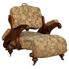 an old fashioned chair with floral upholstered fabric