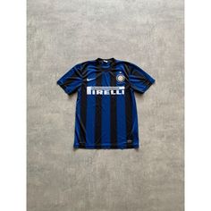 a blue and black soccer jersey with the word irella on it, sitting against a gray wall