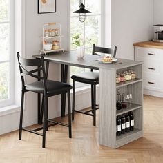 a kitchen table with two chairs and bottles on it