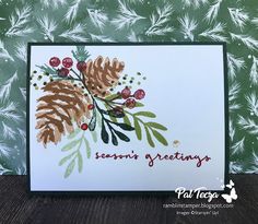 a close up of a card with pine cones and berries on it, which says seasons greetings