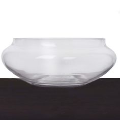 a clear bowl sitting on top of a wooden table