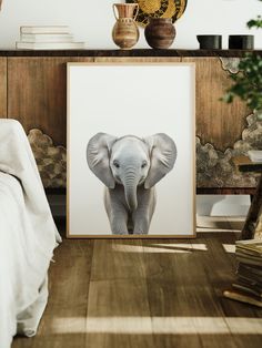 an elephant is standing in front of a painting on the wall next to a bed