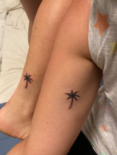 two palm trees tattoo on both arms