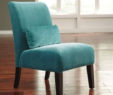 a blue chair sitting on top of a hard wood floor