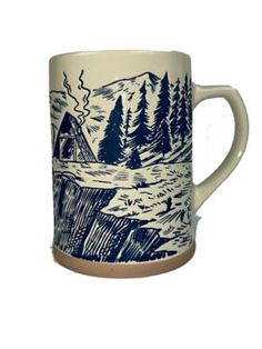 a coffee mug with an image of a tent in the woods on it's side