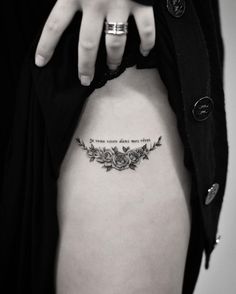 a woman's stomach with a quote tattooed on the back of her lower body