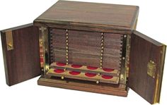 an old wooden box with red and gold coins in it's door open on a white background