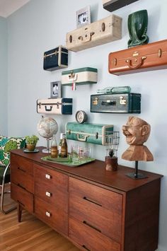 a dresser with many suitcases on the wall