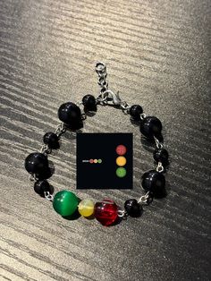 a bracelet with four different colored beads on it