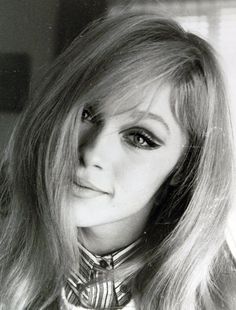 black and white photograph of a woman with long blonde hair wearing a bow - tie