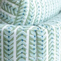 a close up view of the back end of a green and white patterned sofa cushion