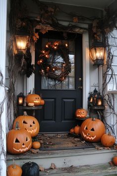 pumpkins are sitting on the front steps of a house with lanterns and wreaths