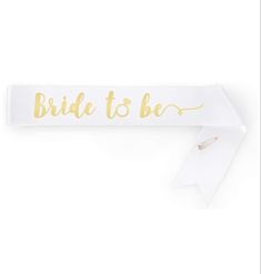 the bride to be sash is shown with gold lettering