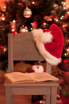 a santa hat sitting on top of an open book