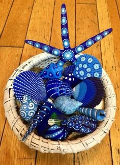 a basket filled with blue items on top of a wooden floor