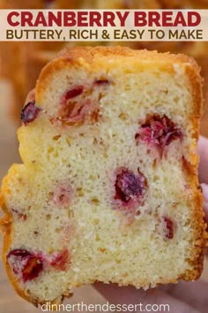 a close up of a person holding a piece of cranberry bread