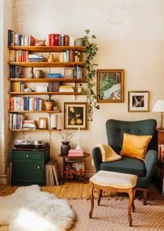 a living room filled with furniture and bookshelves next to a wall covered in pictures