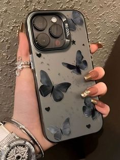 a woman's hand holding an iphone case with butterflies on it