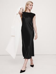 Our version of the season's slip dress styles, we cut this one from a luxuriously soft and silky satin quality, which we cut on the bias to achieve a beautiful drape.  Fit & flare.  Sustainability: Made with LENZING™ ECOVERO™, a breathable fiber derived from certified renewable wood sources, produced using methods that reduce water impact and emissions by up to 50% compared to traditional viscose.  Crew neck with button-keyhole at back.  Unlined.  Fit & flare.  Sleeveless.  Midi length.  Model: Wimbledon Style, Moving Closet, Quoi Porter, Satin Midi Dress, Black Midi, Satin Dress, Workwear Dress, Black Midi Dress, Dress Styles