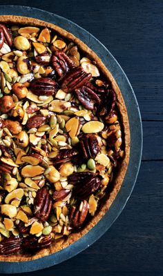 an overhead view of a pie with nuts