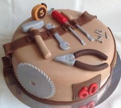 a cake with tools on it sitting on a table