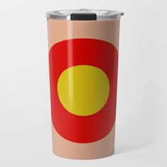 a red, yellow and orange circle on a tan colored travel mug with black lid