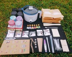 an assortment of crafting supplies laid out on the grass