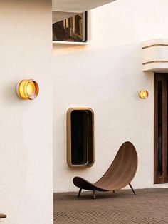 a chair sitting in front of a white wall next to a window and door frame