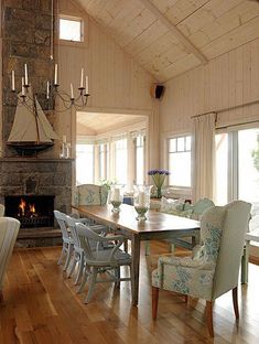 a dining room table with chairs and a fire place in the corner next to it